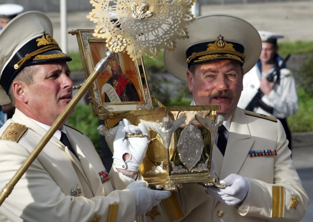 MOS01 - 20020828 - VLADIVOSTOK, RUSSIAN FEDERATION : Russian Navy admirals carry a box with remains of the Saint Russian warrior Admiral Fyodor Ushakov, 28 August, 2002. The remains were presented to Vladivostok Church to bless and defend Russian Far East navy in Vladivostok. EPA PHOTO EPA SERGEI CHIRIKOV